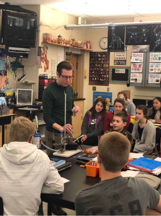 dr.-hill-showing-students-how-different-metal-compounds-burn-different-colors-in-a-flame1
